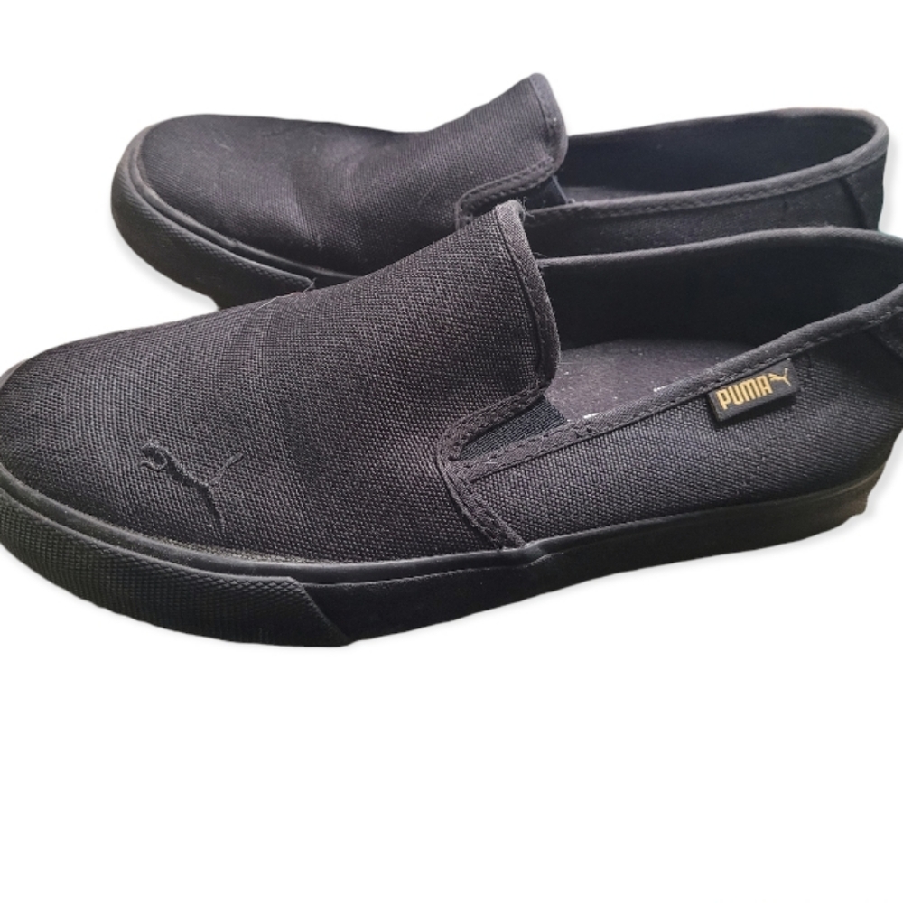 Black puma slip on sneakers with gold puma detail